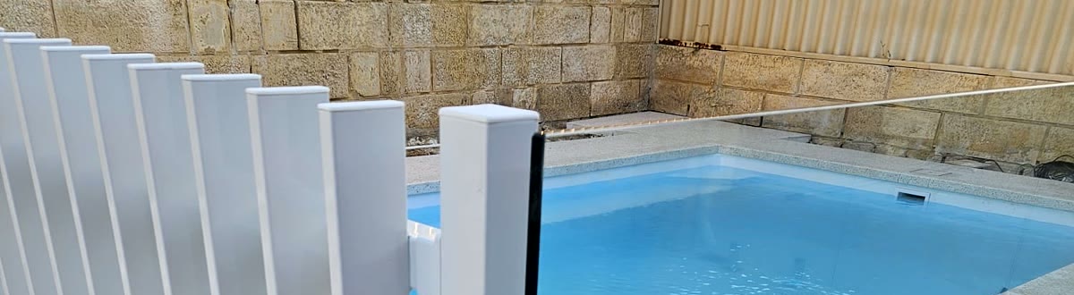 Close-up of a white blade pool fence meeting frameless glass on one Perth pool